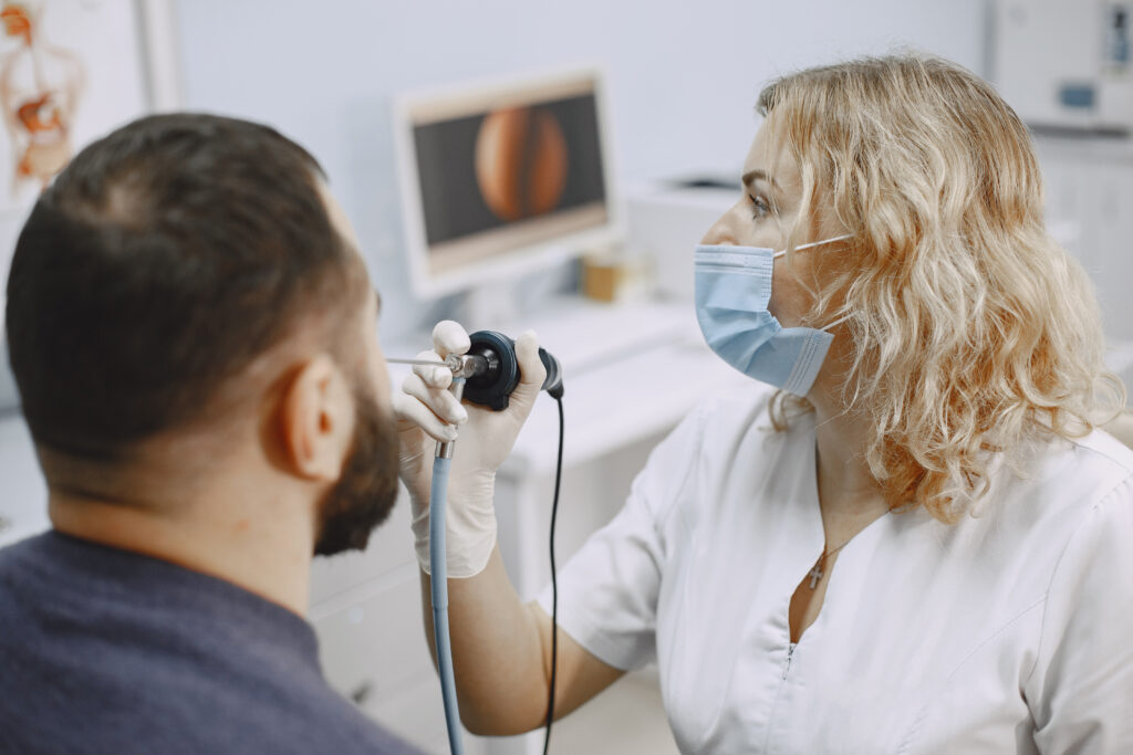 doctor talking to her male patient at office